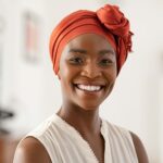 Smiling mature black woman with african headscarf
